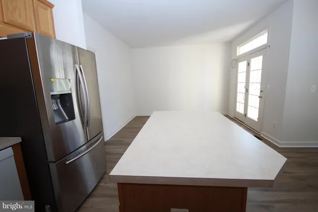 a kitchen with stainless steel appliances granite countertop a refrigerator sink and cabinets