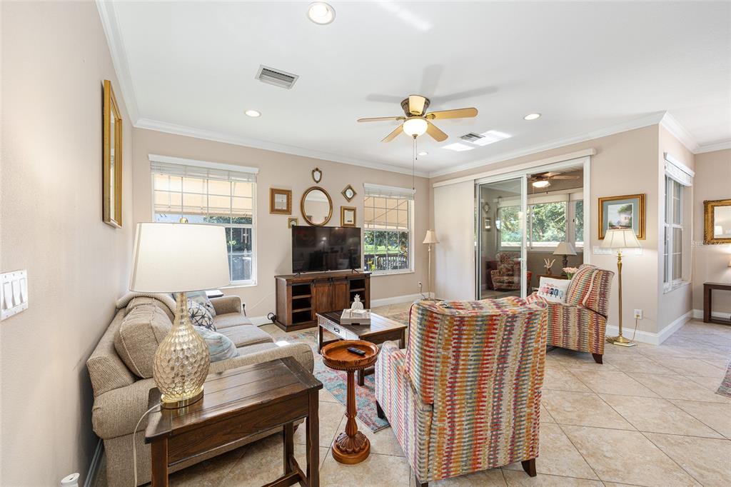 3304 Southwest 38th Street Ocala, FL 34474 - Photo 12 of 21 a living room with furniture a flat screen tv and a large window