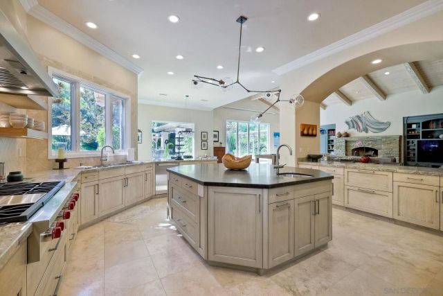 a kitchen with stainless steel appliances granite countertop a sink and a stove