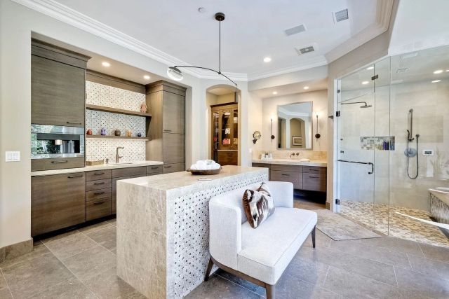 a bathroom with a granite countertop sink mirror and a toilet