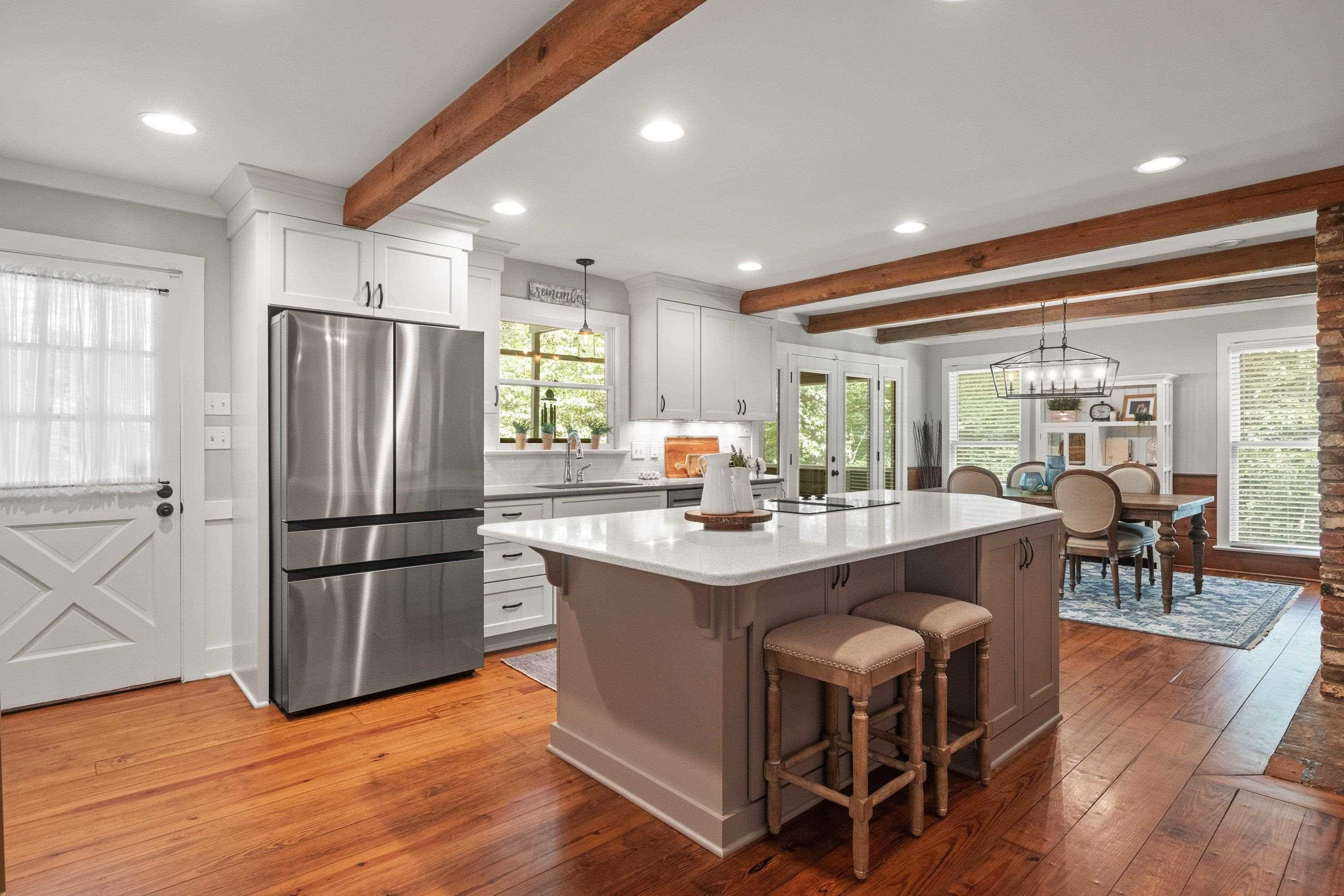 2420 Windsor Trail Raleigh, NC 27615 - Photo 15 of 72 a kitchen with stainless steel appliances a dining table chairs refrigerator and wooden floor