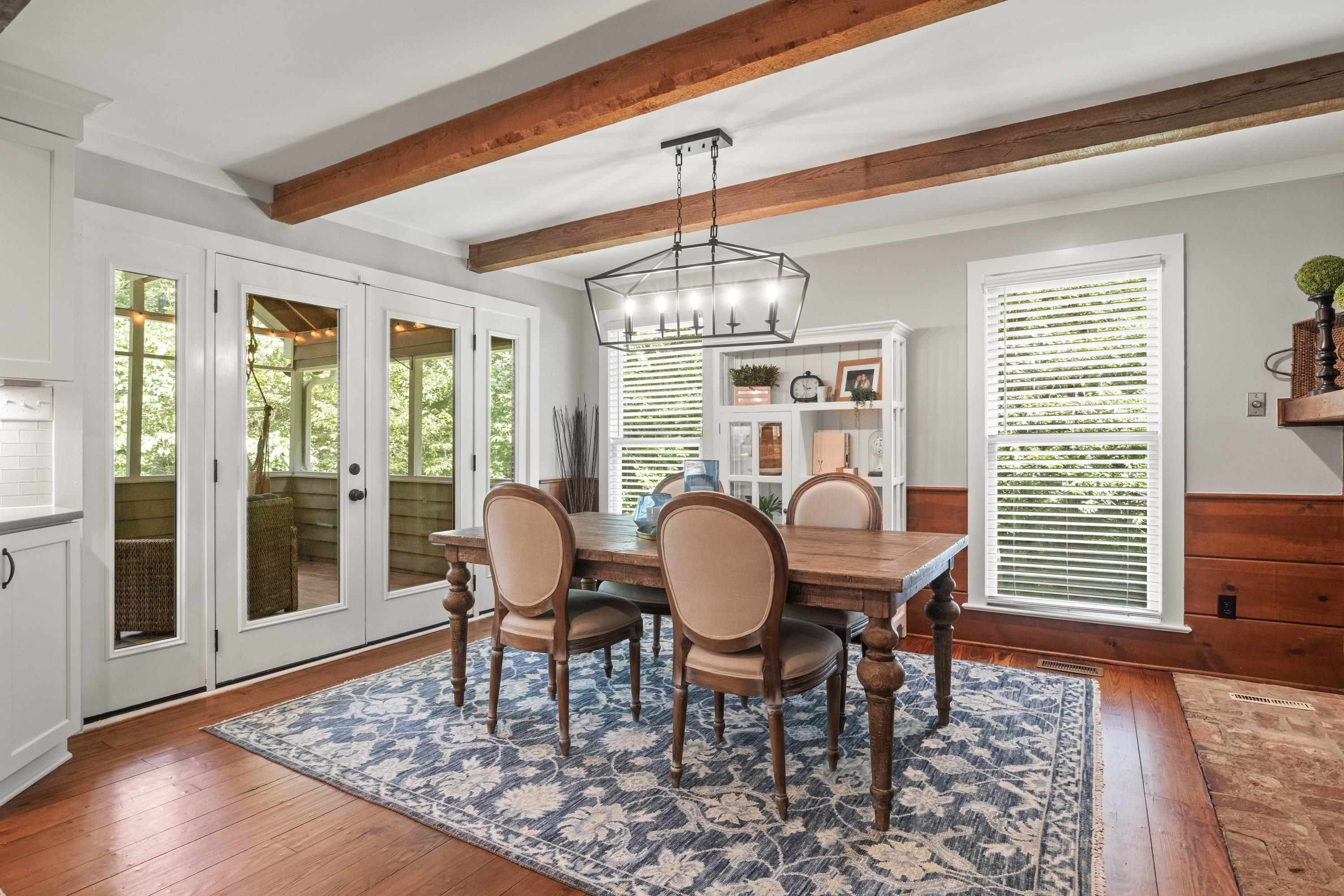 2420 Windsor Trail Raleigh, NC 27615 - Photo 22 of 72 a dining room with furniture a rug and wooden floor
