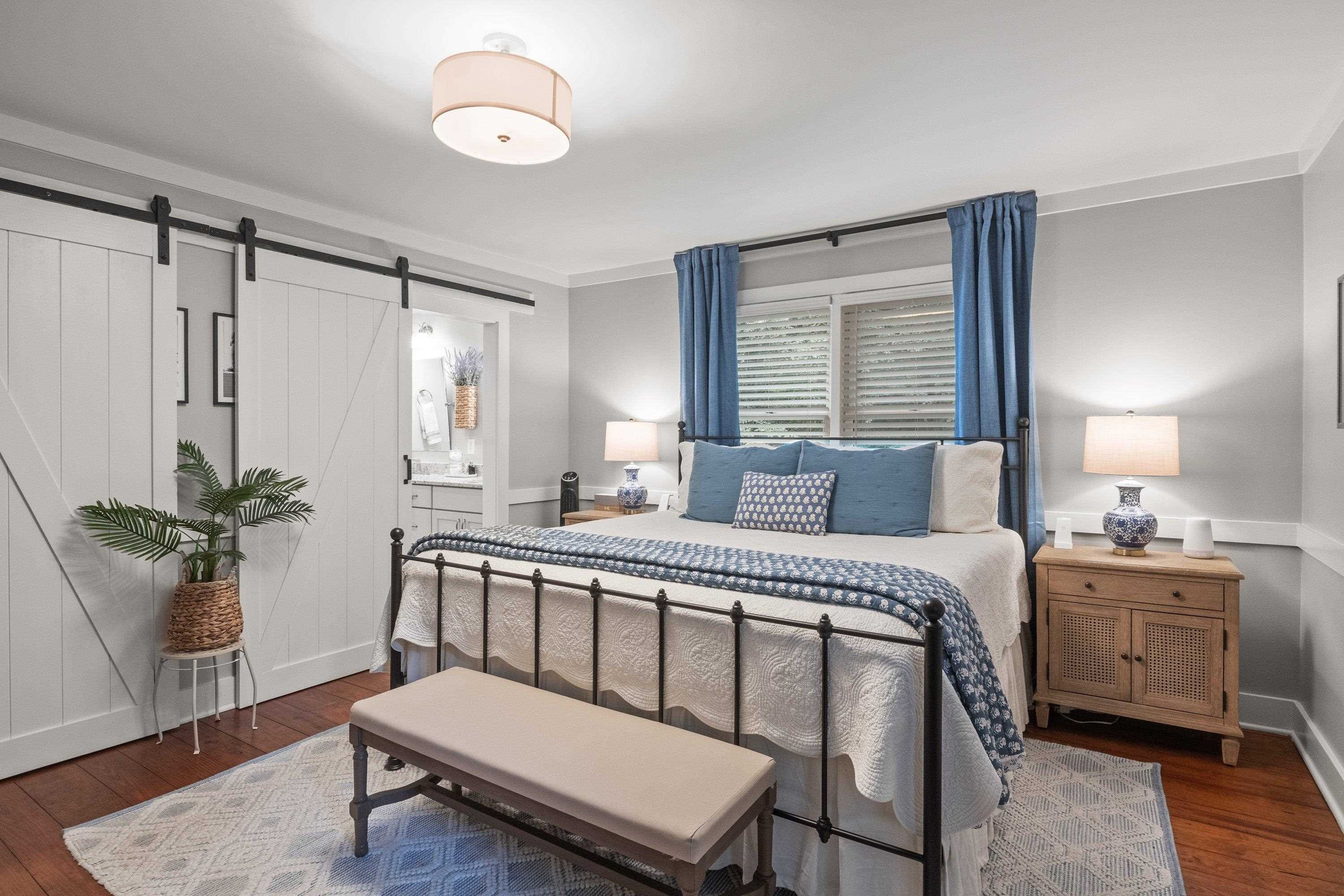 2420 Windsor Trail Raleigh, NC 27615 - Photo 28 of 72 a spacious bedroom with a bed and a table in it