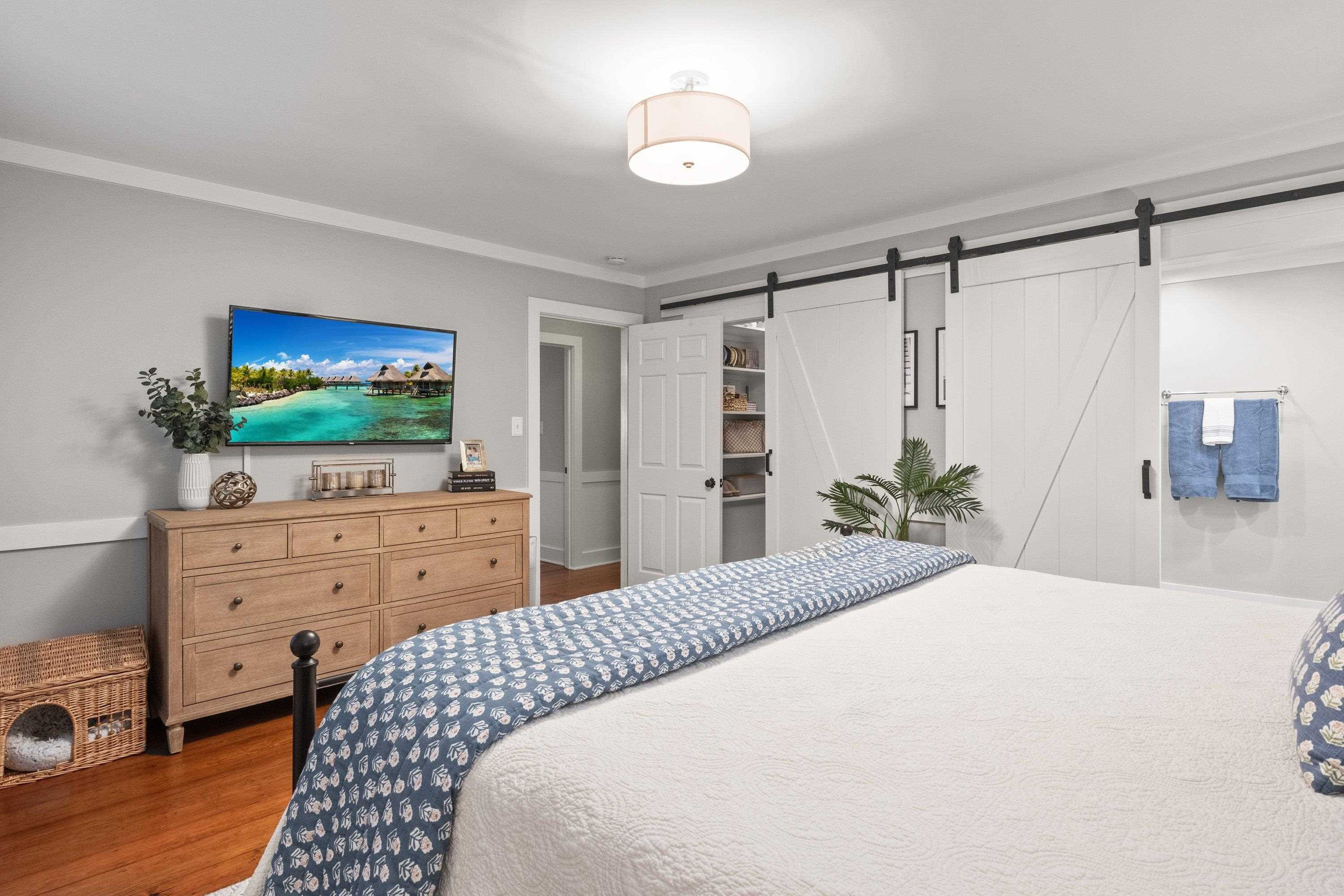 2420 Windsor Trail Raleigh, NC 27615 - Photo 29 of 72 a bedroom with a bed and a flat screen tv in it