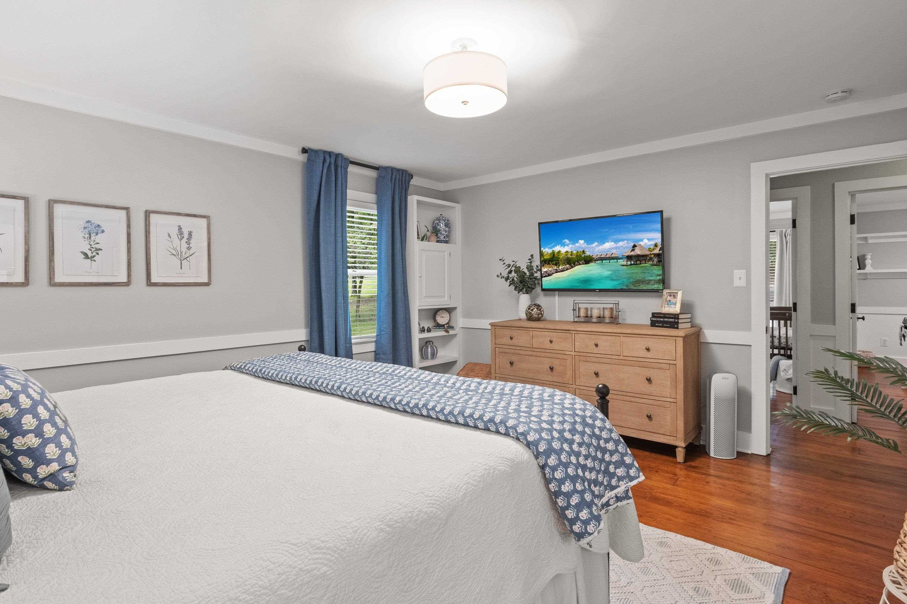 2420 Windsor Trail Raleigh, NC 27615 - Photo 30 of 72 a bedroom with a bed and a flat tv screen on dresser