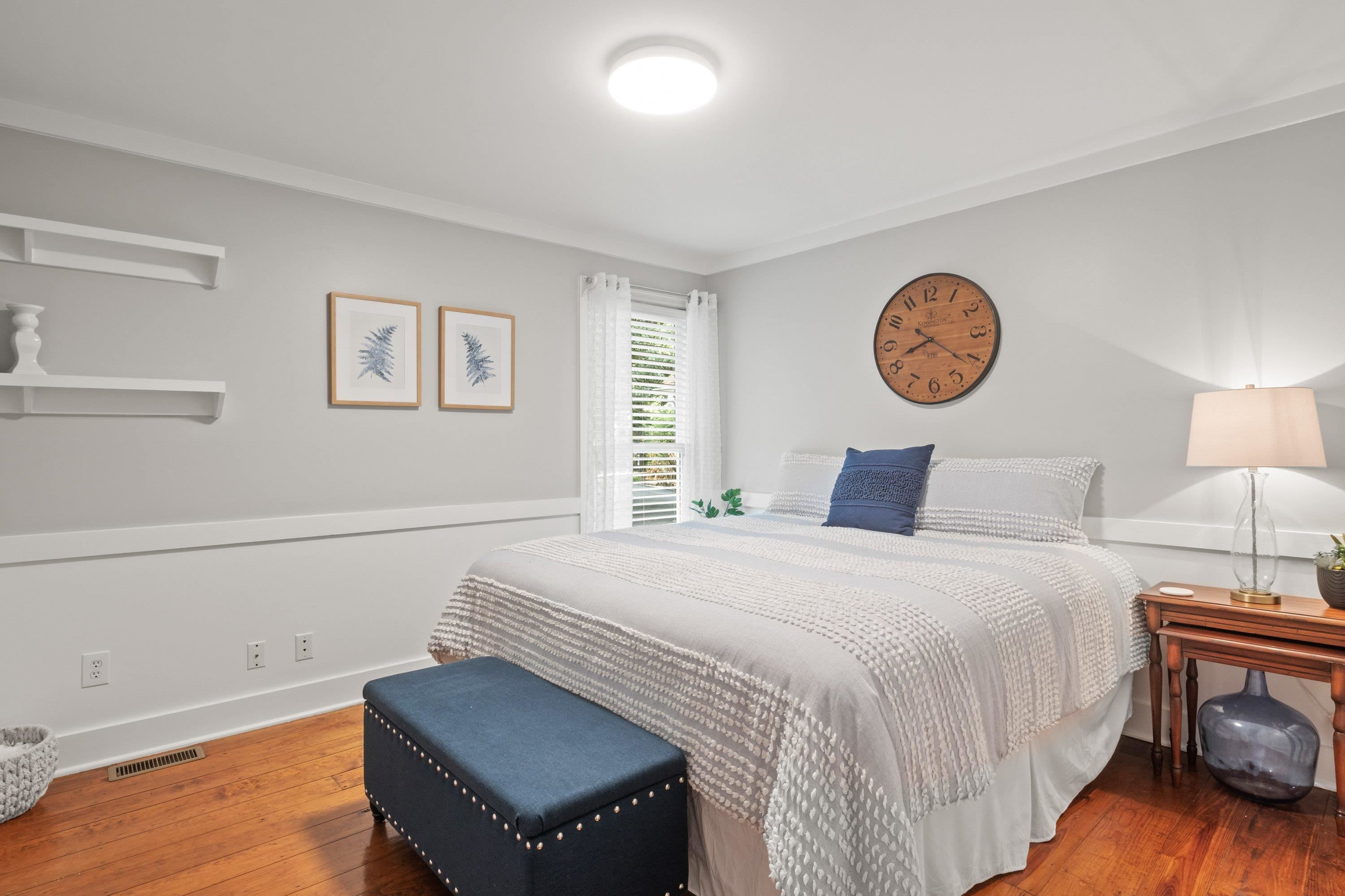 2420 Windsor Trail Raleigh, NC 27615 - Photo 38 of 72 a bedroom with a bed and a lamp on dresser