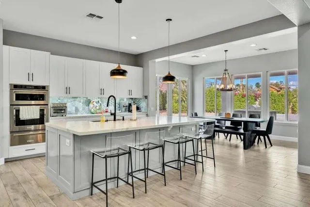a living room with furniture a pool table and a couch