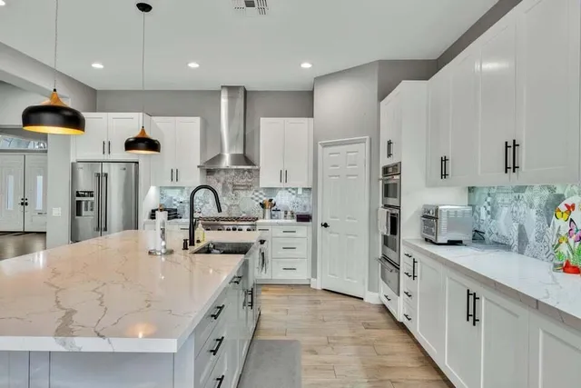 a kitchen with stainless steel appliances lots of counter top space