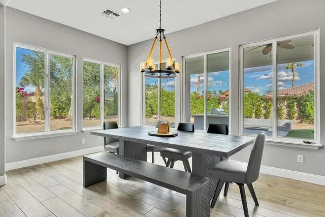 a bathroom with a granite countertop sink toilet and mirror