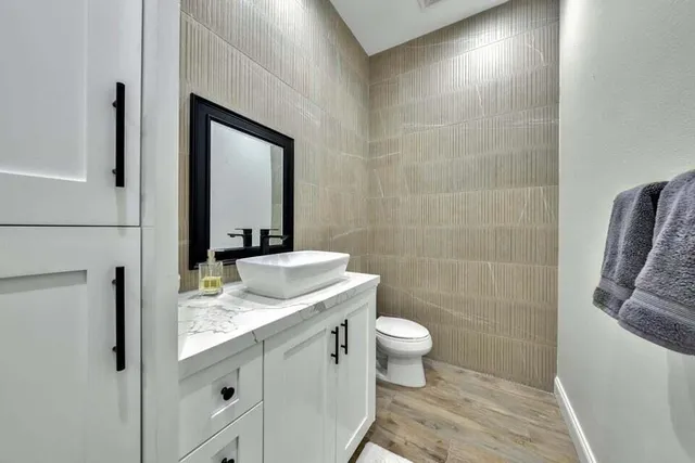 a spacious bedroom with a bed a couch and a large window