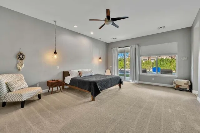 a spacious bedroom with a bed and large windows