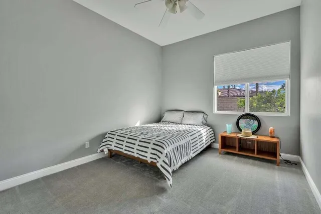 a bedroom with bed and a chandelier
