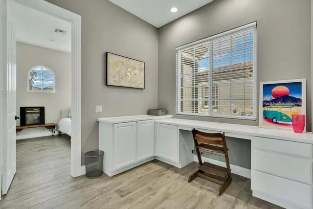 a workspace with furniture and a window