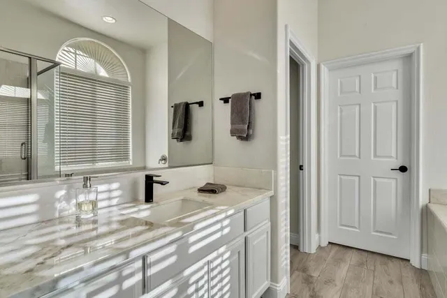 a bathroom with a bathtub and shower