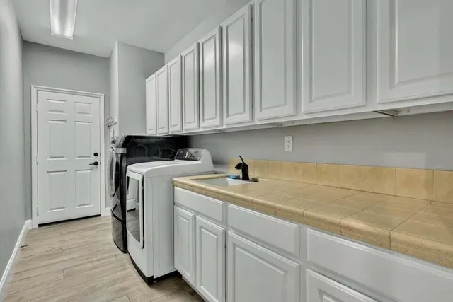 a front view of a house with a garden and palm trees