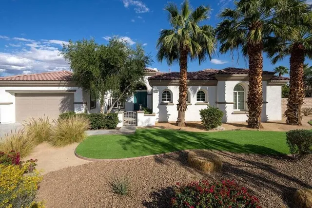 a view of a patio with couches and a table and chairs with garden view