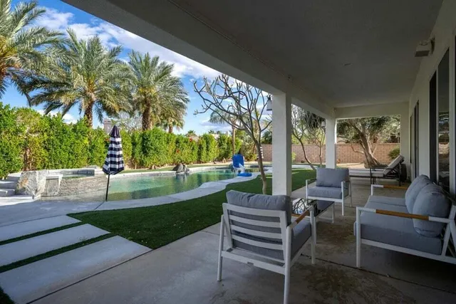 a view of a patio with table and chairs and a fire pit