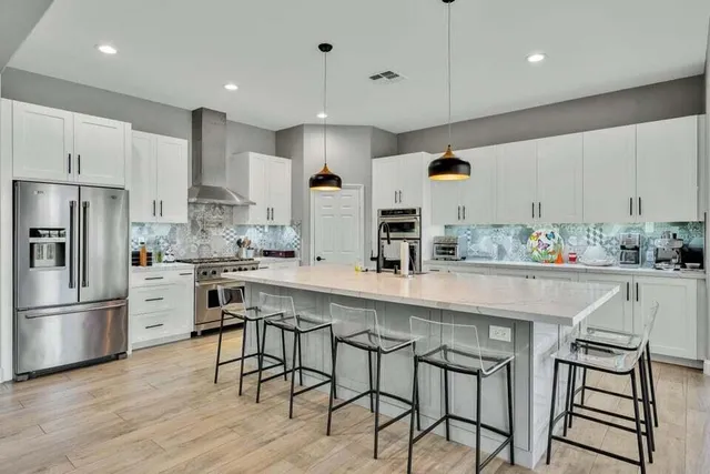 a kitchen with appliances a sink and cabinets