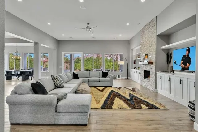 a living room with furniture and view of kitchen