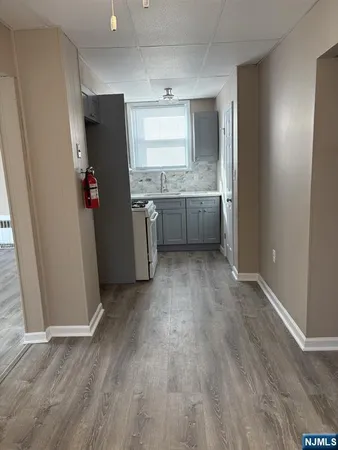 a view of a kitchen with wooden floor and electronic appliances