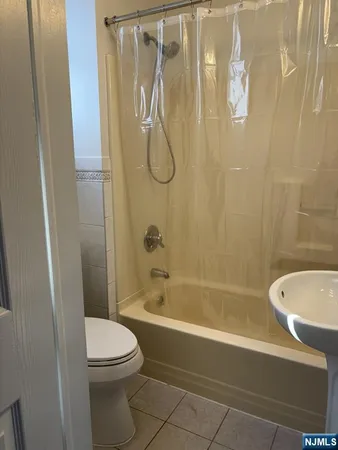 a bathroom with a toilet and shower