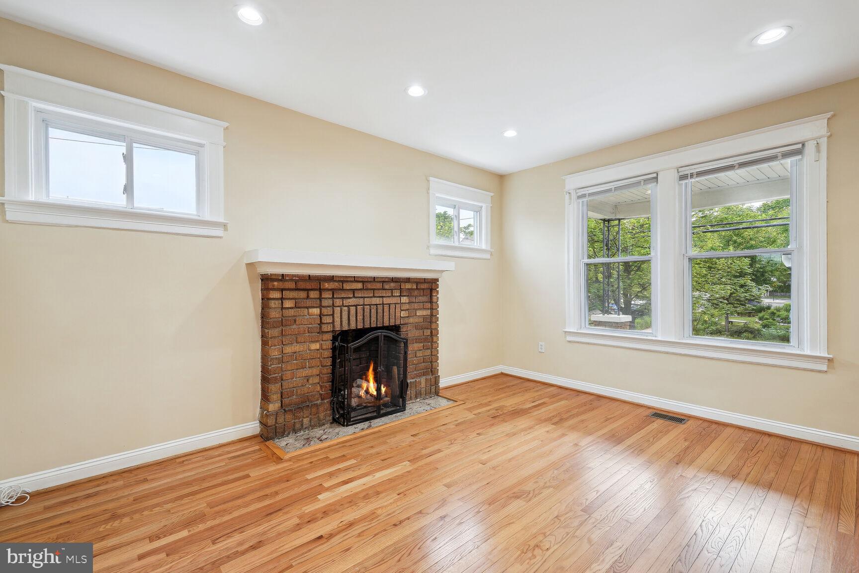 4528 4th Street Northwest Washington, DC 20011 - Photo 5 of 28 an empty room with wooden floor fireplace and windows