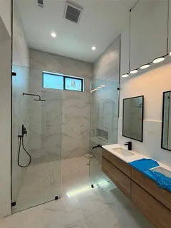 a kitchen with kitchen island granite countertop a sink a refrigerator and a stove