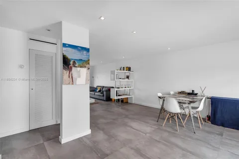 a view of a workspace with furniture and a kitchen