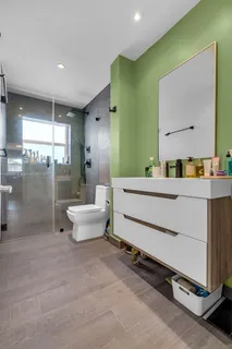 a bathroom with a double vanity sink toilet mirror and tub