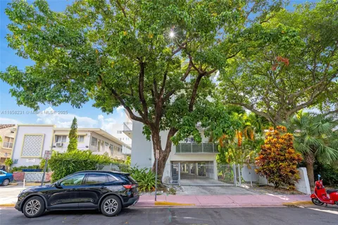 a car parked in front of a white house