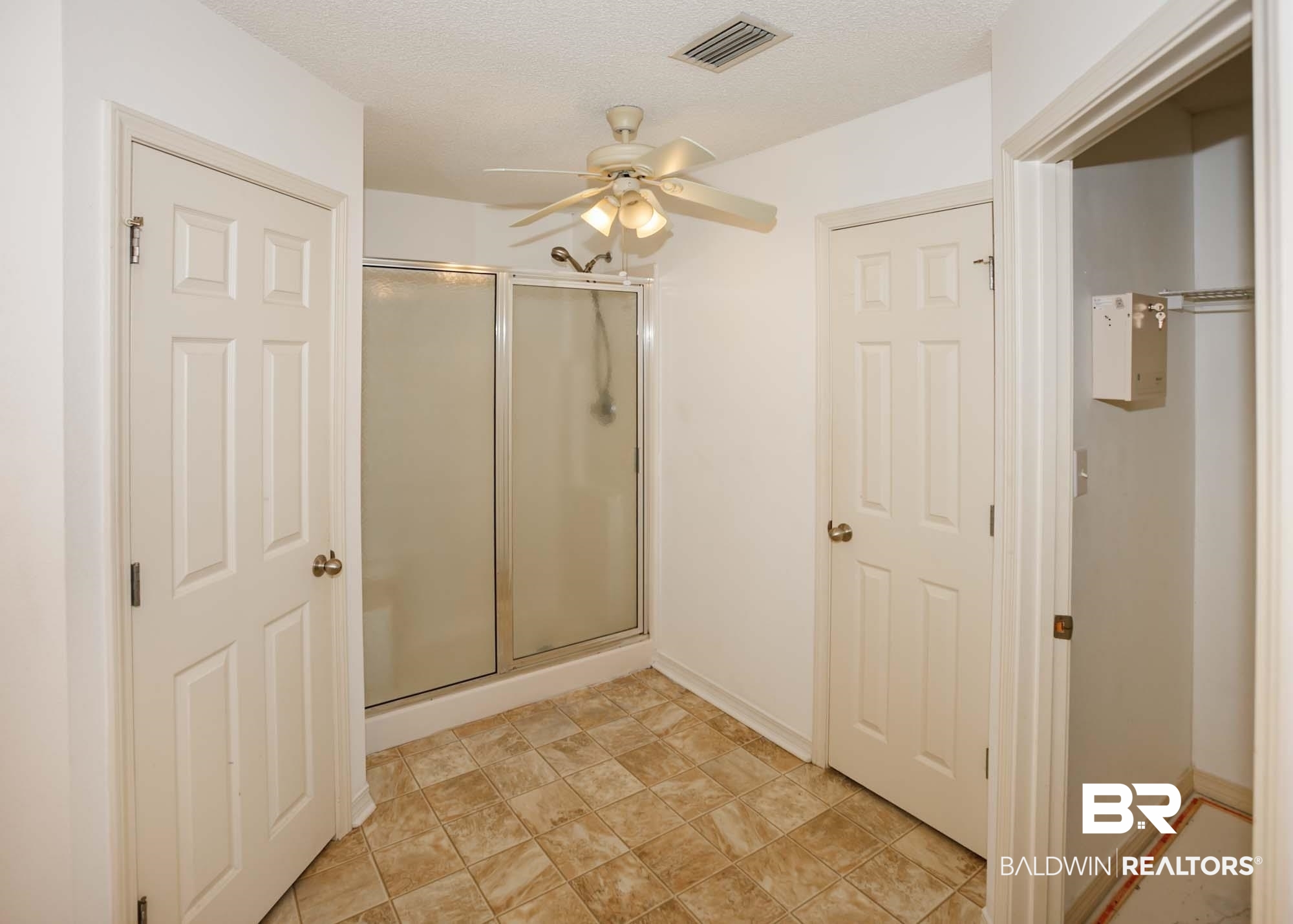 2530 Ashburn Lane Foley, AL 36535 - Photo 25 of 46 Bathroom featuring a textured ceiling, a shower with door, and ceiling fan