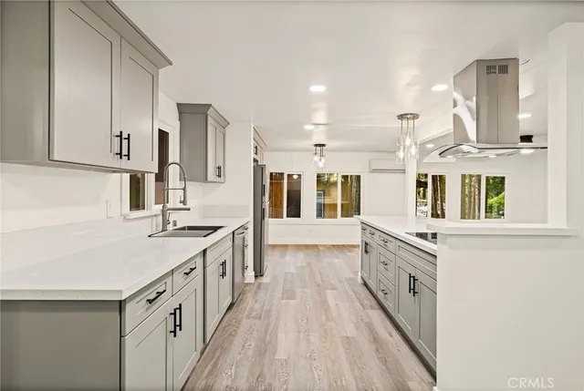 a kitchen with stainless steel appliances a refrigerator sink and cabinets