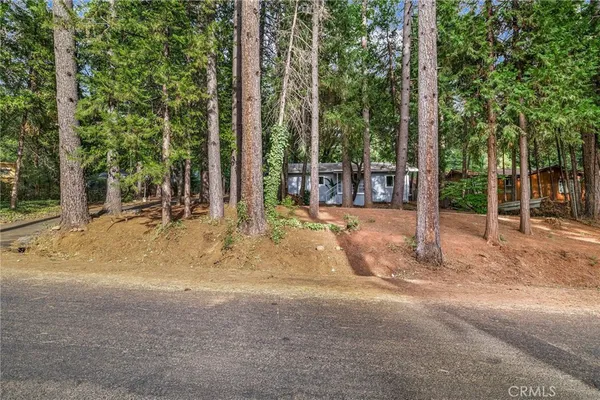 a view of a house with a tree in the background