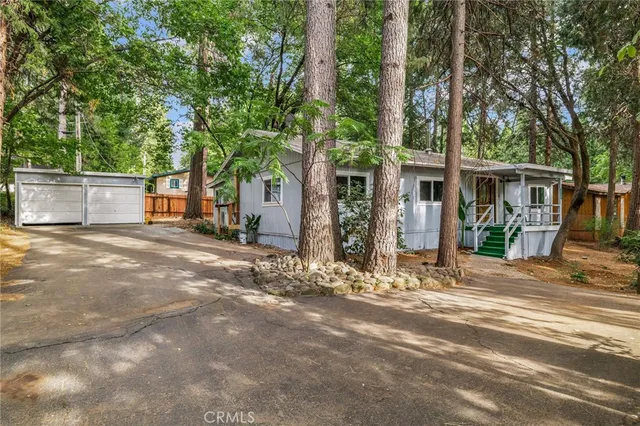 a view of a house with a tree in the background