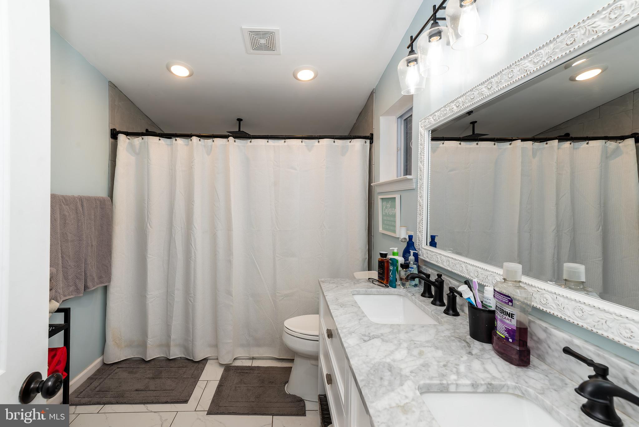997 Williamstown Road Franklinville, NJ 08322 - Photo 19 of 62 a bathroom with a granite countertop sink and a shower