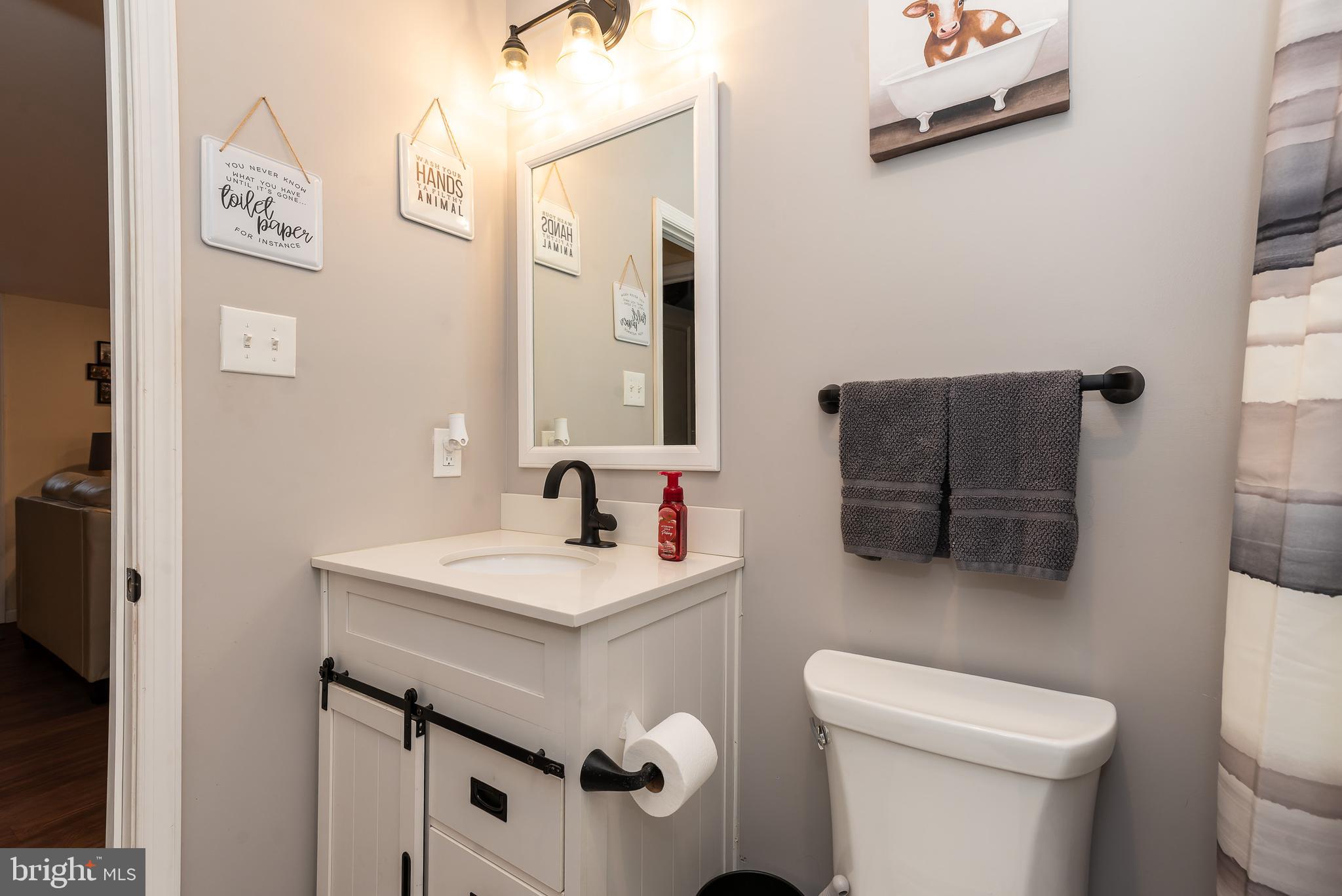 997 Williamstown Road Franklinville, NJ 08322 - Photo 31 of 62 a bathroom with a toilet sink and mirror