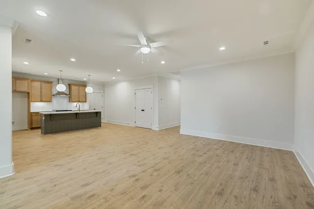 a view of kitchen and kitchen with a sink wooden floor kitchen view