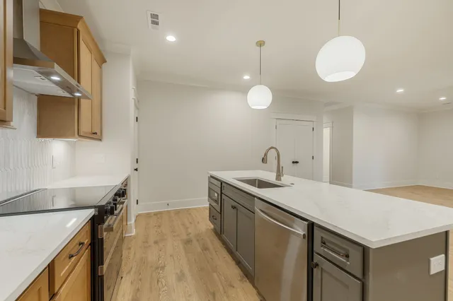 a kitchen with a sink and a stove