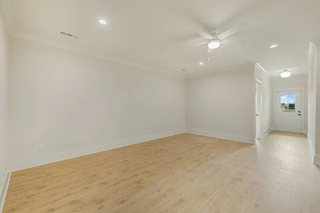 a view of an empty room with a kitchen