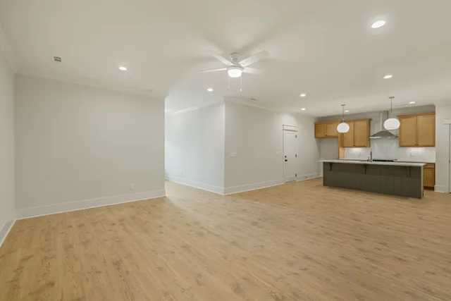 a kitchen with a sink cabinets and wooden floor