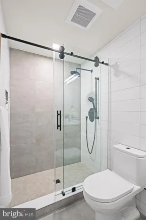 a bathroom with a toilet and a shower