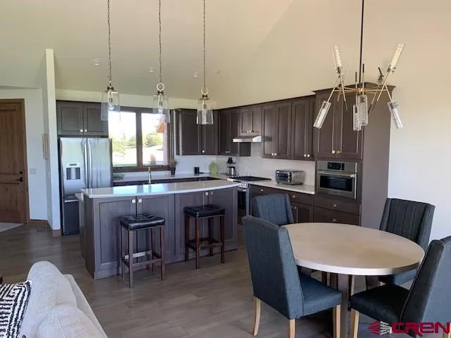 a living room with furniture and floor to ceiling windows