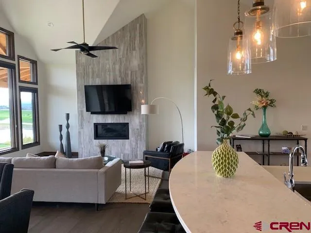 a kitchen with kitchen island a dining table chairs stainless steel appliances and cabinets