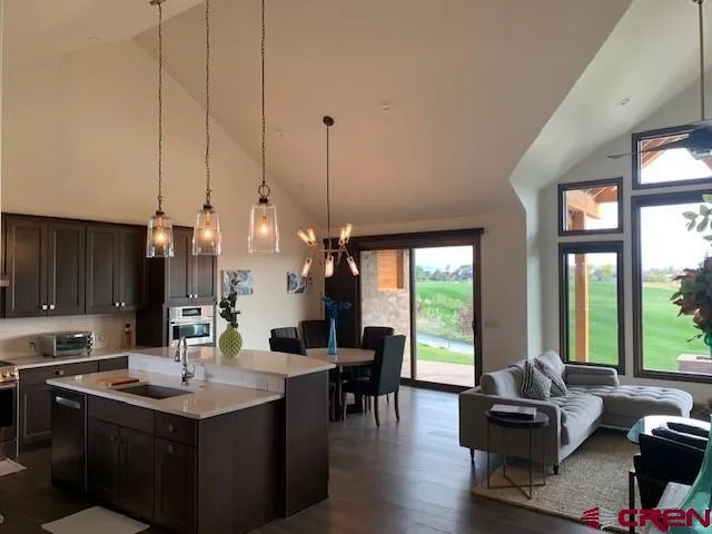 a living room with furniture and a floor to ceiling window