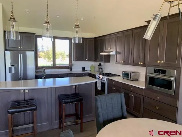 a kitchen with a sink stove and microwave