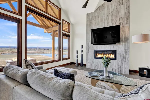 a living room with fireplace furniture and a flat screen tv