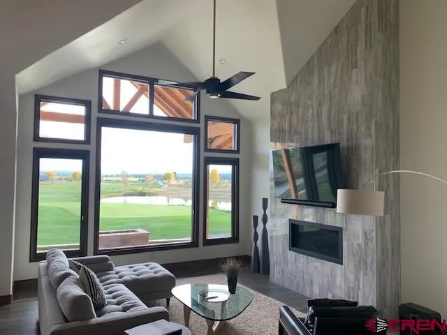 a kitchen with granite countertop a dining table chairs and a refrigerator