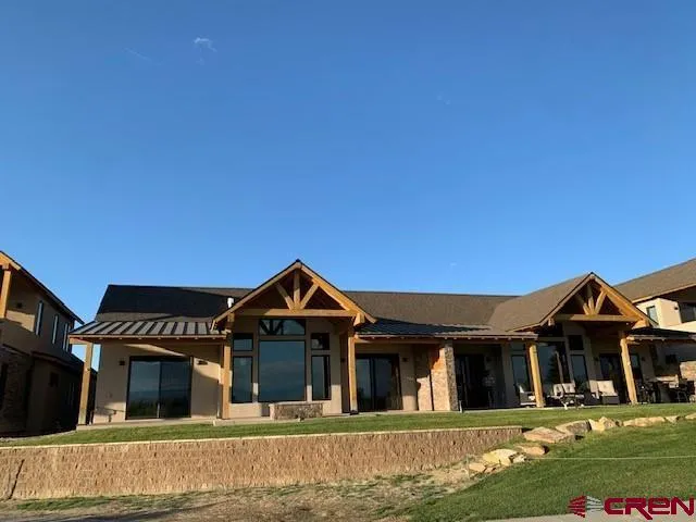 a view of a house with a yard porch and sitting area