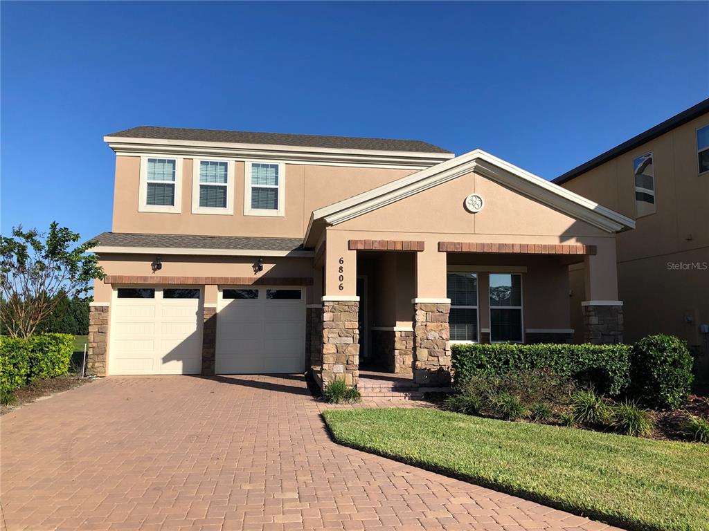 6806 Trellis Vine Loop Windermere, FL 34786 - Photo 1 of 9 a front view of a house with a yard