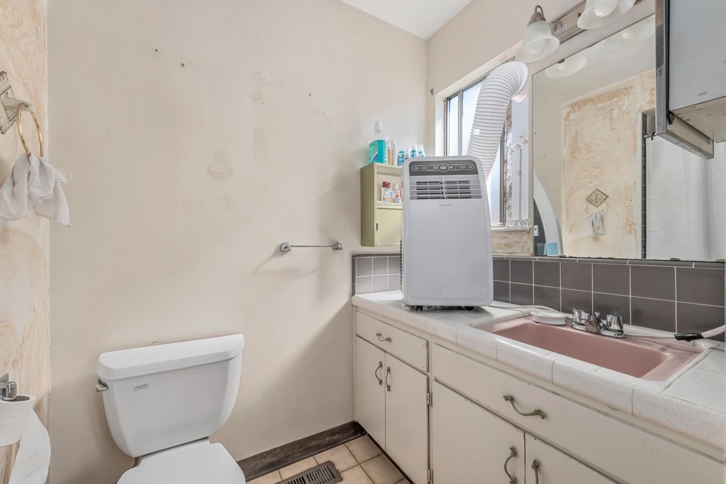 1651 Salisbury Drive San Jose, CA 95124 - Photo 16 of 22 a bathroom with a toilet sink and mirror